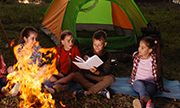 kids sitting around a campfire