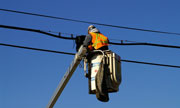 utility worker fixing a power line